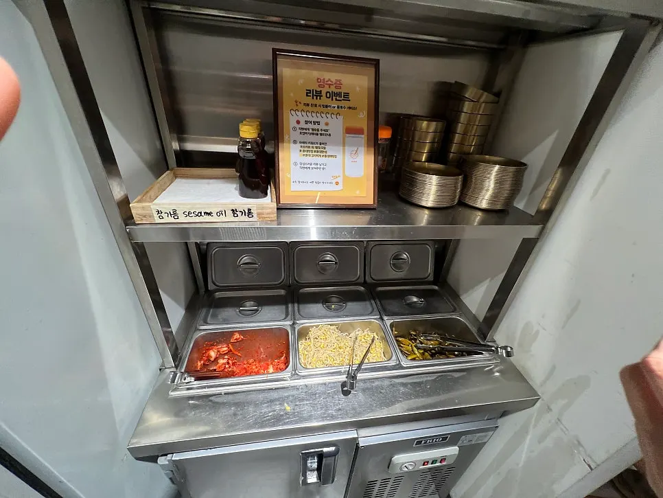 Self-serve side dish bar with kimchi and bean sprouts