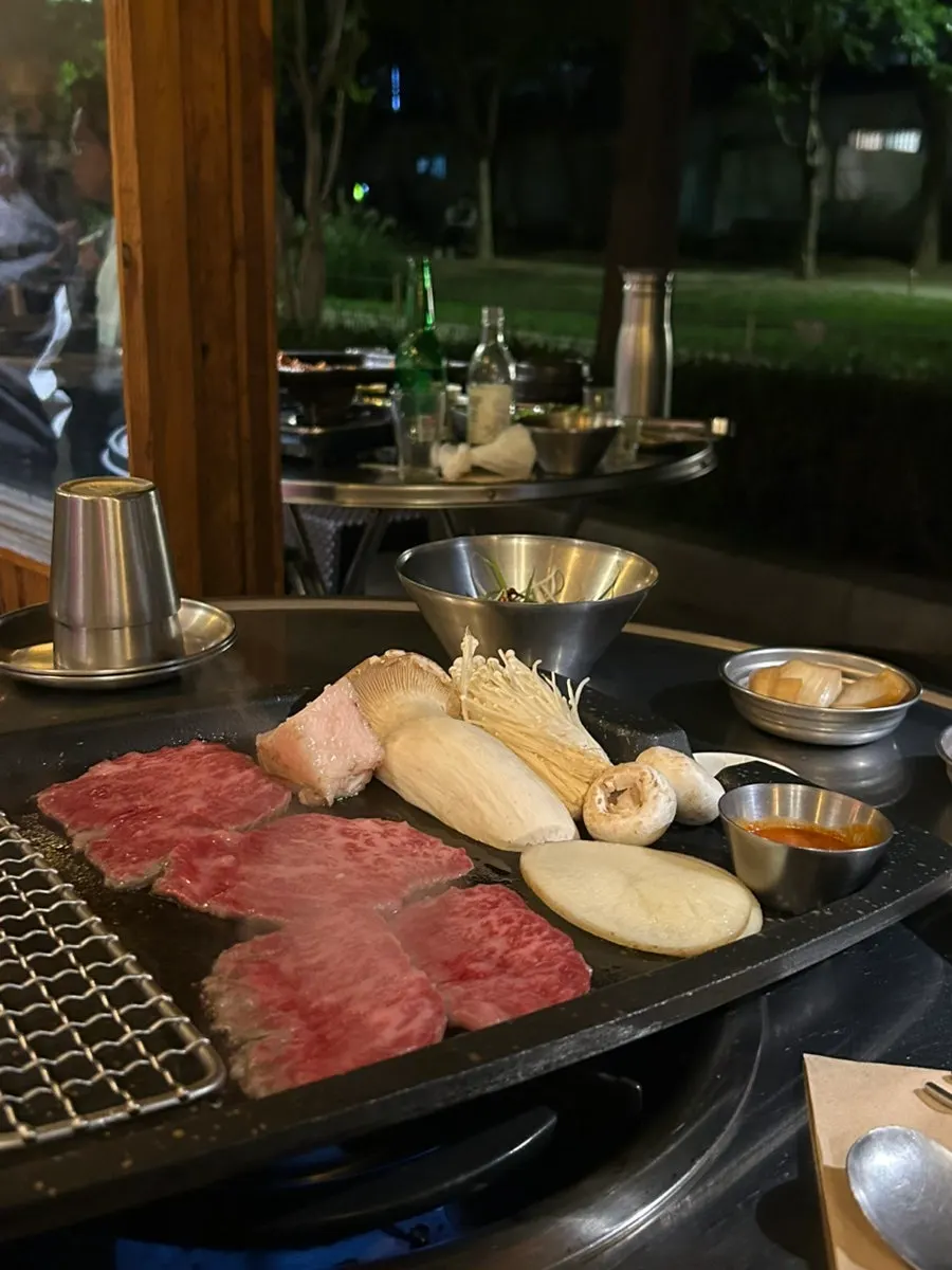 Table setting of grilled meat and accompaniments