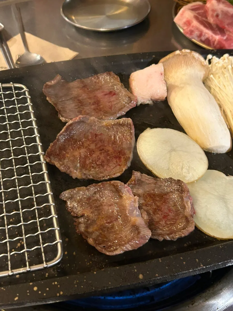 Staff grilling Korean beef salchisal