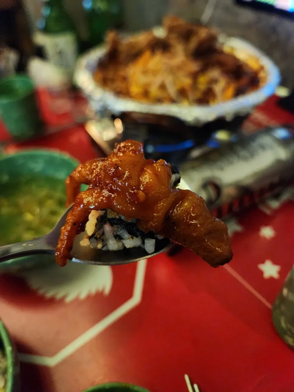 Spicy chicken feet piled on top of a rice ball