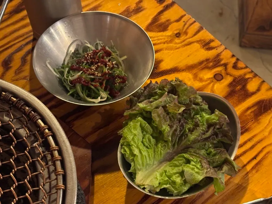 Side dishes including white kimchi and pickled onions