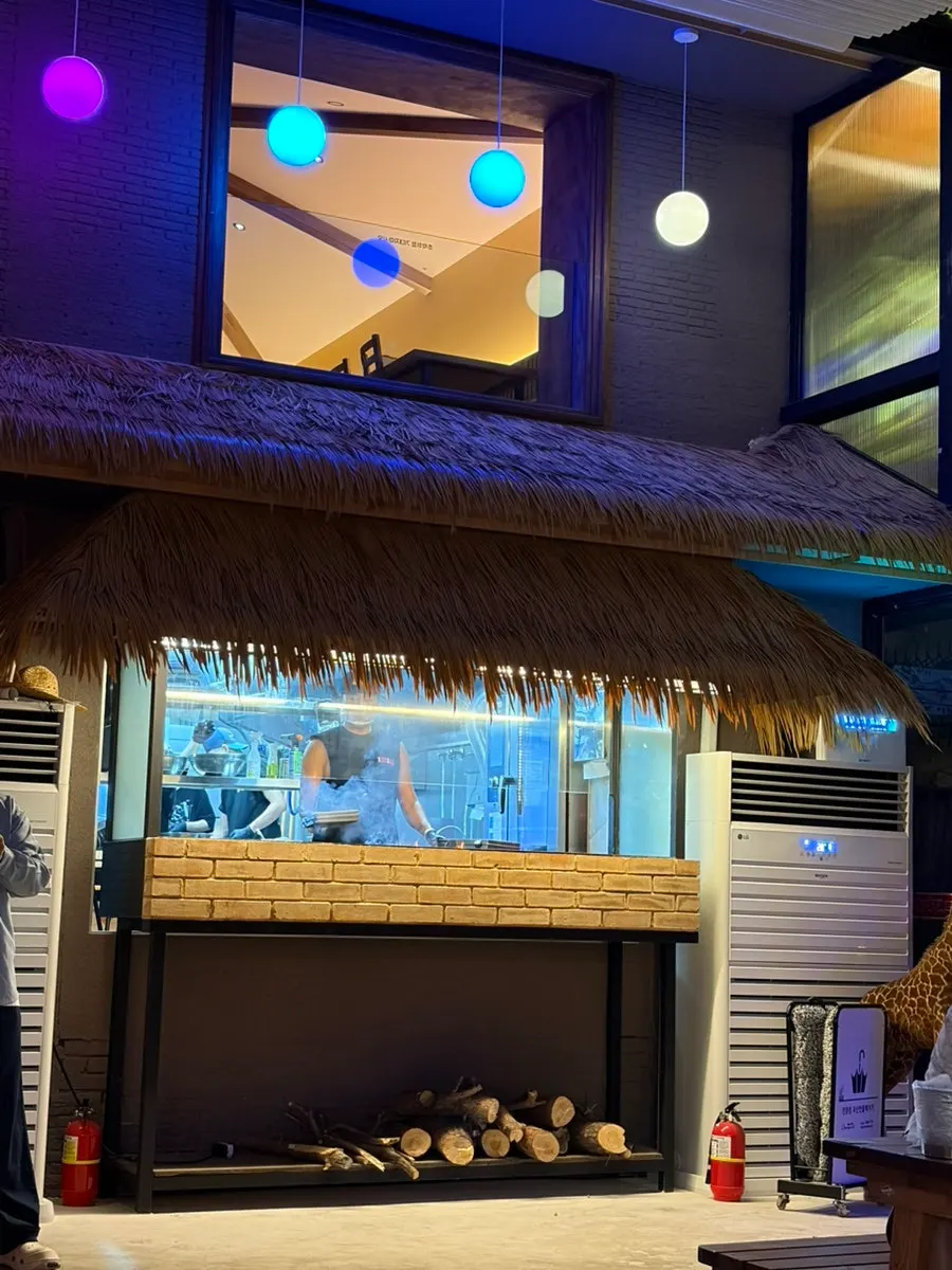 Hongdae outdoor-bar atmosphere with a giant screen