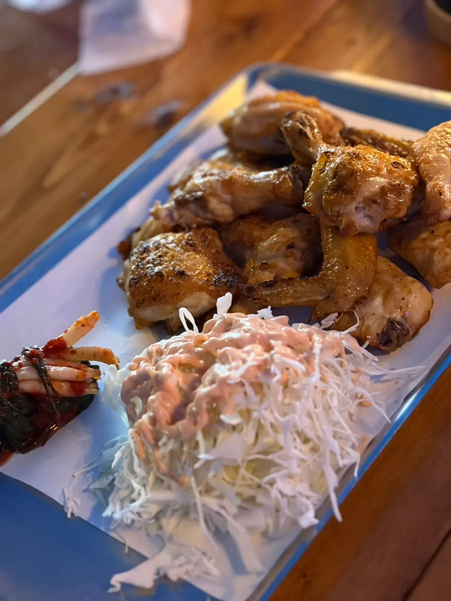 Grilled chicken with cabbage salad and scallion kimchi