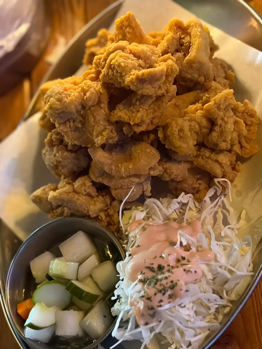 A large chicken leg eaten with scallion kimchi