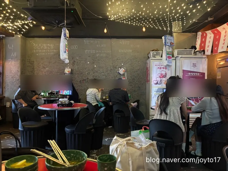 Indoor pojangmacha-style seats packed with customers on an early weekday evening