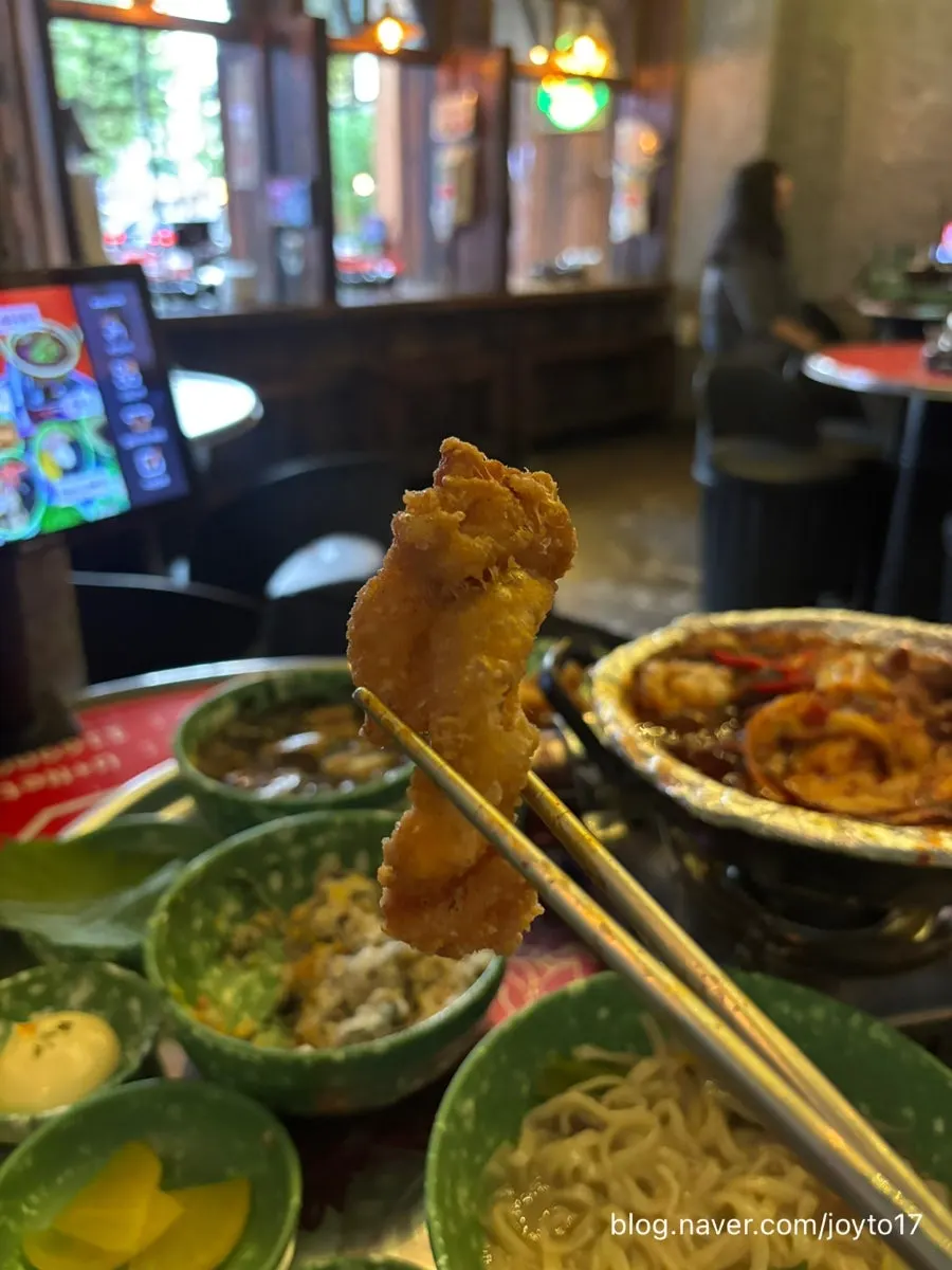 Picking up a piece of chicken skin fritter