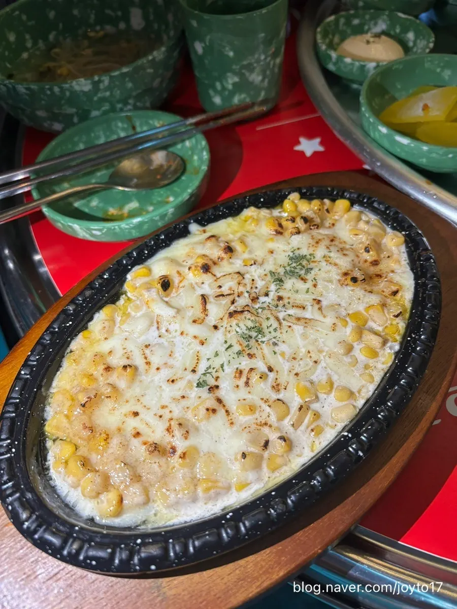 Corn cheese served sizzling on a hot plate