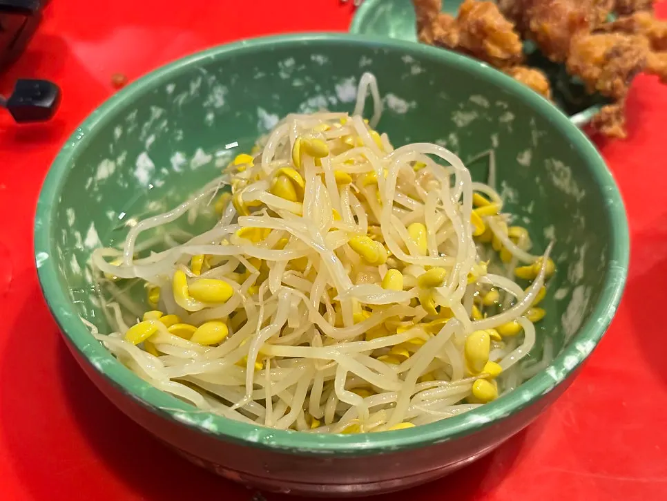 Soup chicken feet topped with a fresh bean sprout refill