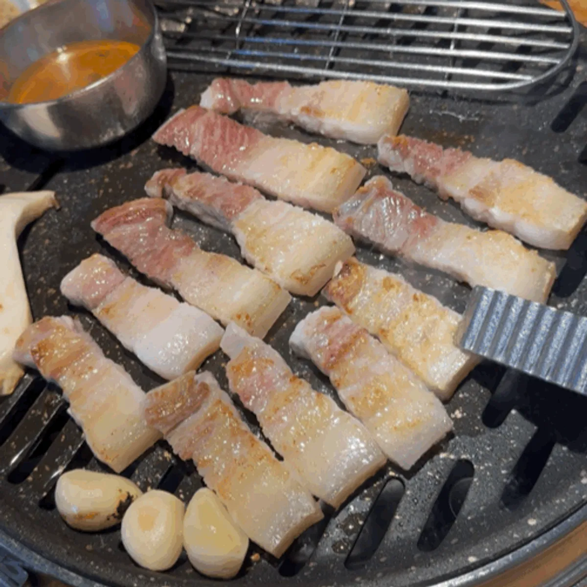 Table setting with salted ogyeopsal at Chopilsal Pork Grill Hongdae Branch