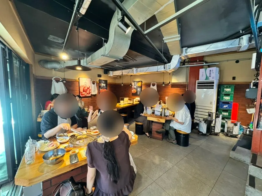 Interior of Chopilsal Pork Grill Hongdae Branch full of customers