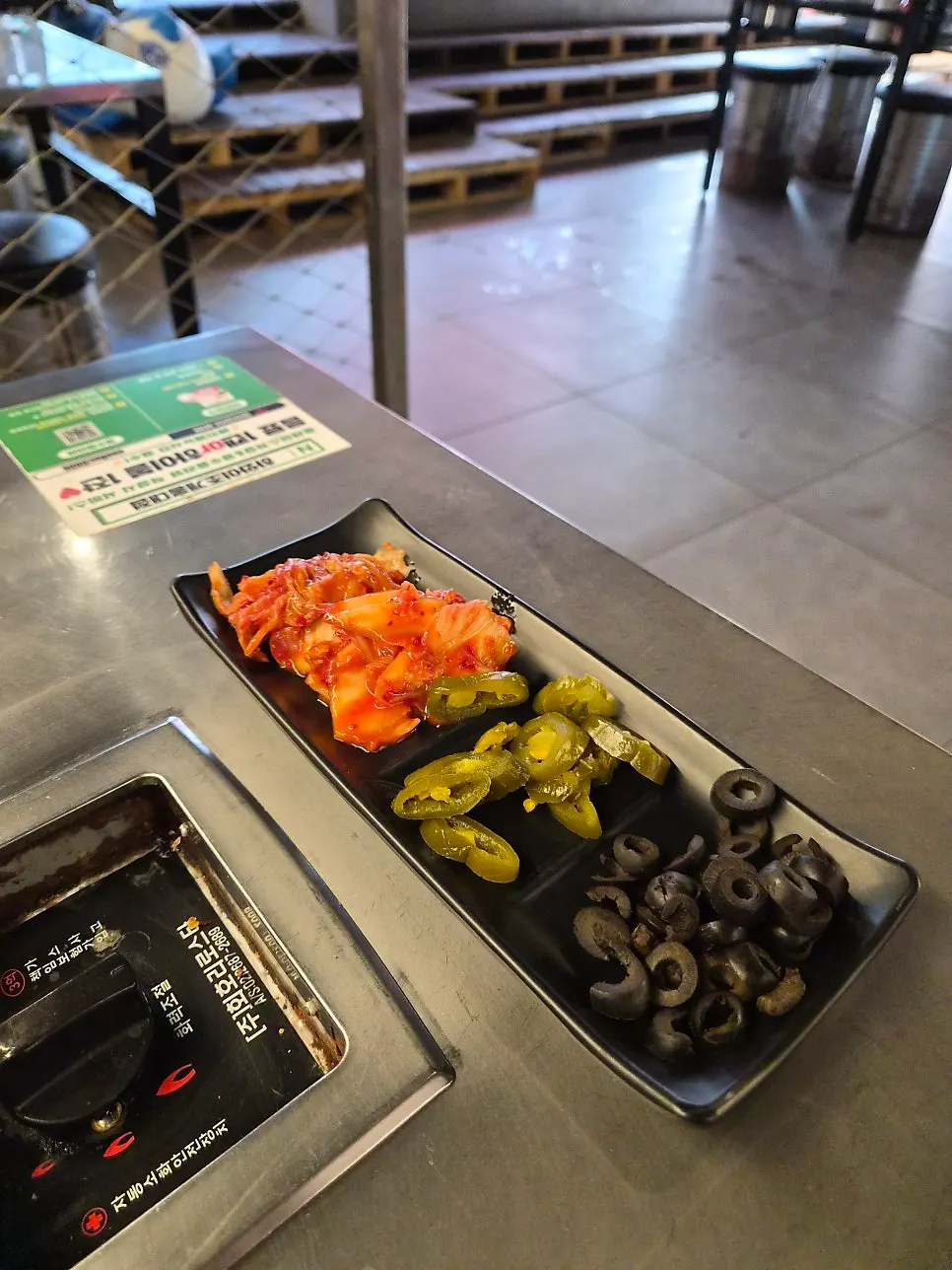 Basic side dishes of kimchi, jalapeños, and olives