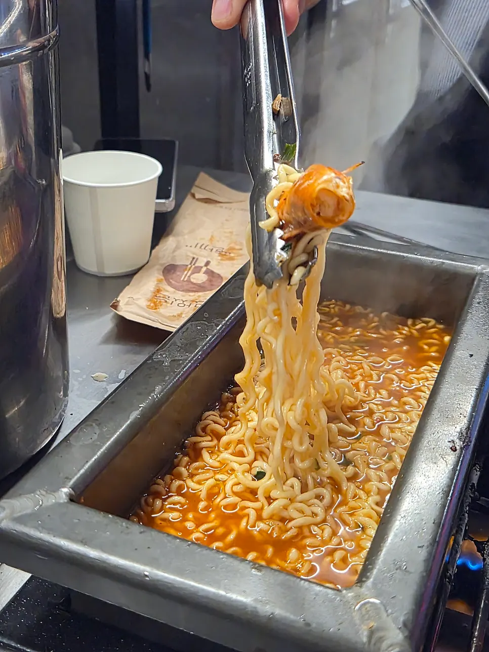 Seafood ramen cooked in mussel soup broth with a shrimp head