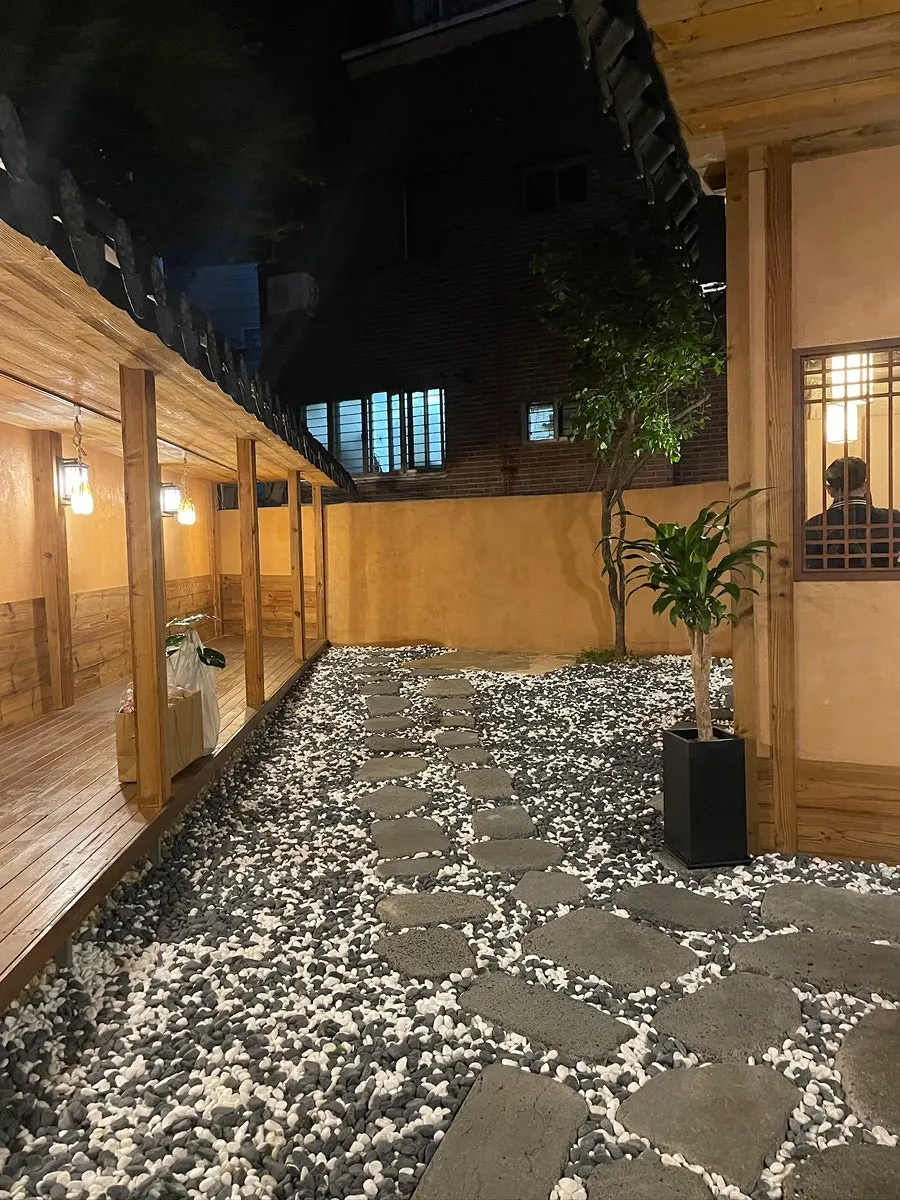 Anok entrance and stone path with a hanok atmosphere