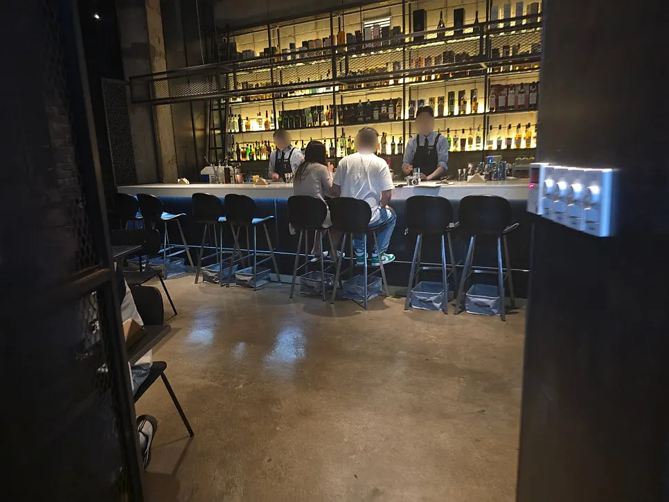 Bottle-lined wall and low lighting inside Bitters