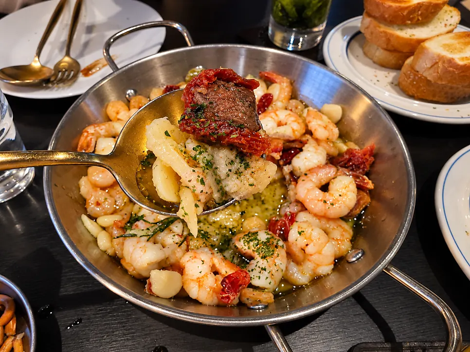Close-up of gambas mixed with dried tomatoes and shrimp