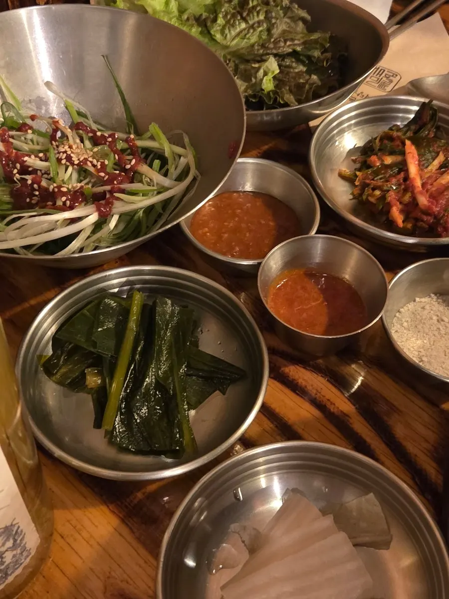 Scallion salad, pickled wild garlic leaves, and white kimchi sides