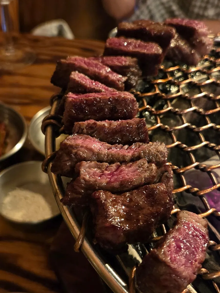 A bite of meat with scallion salad