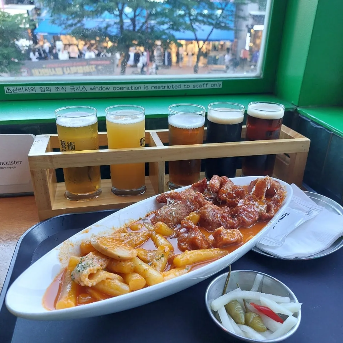 Five-beer craft sampler with rose tteokbokki and boneless chicken