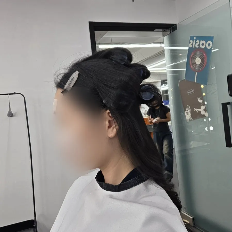 Checking the reference photo brought for a more defined makeup look