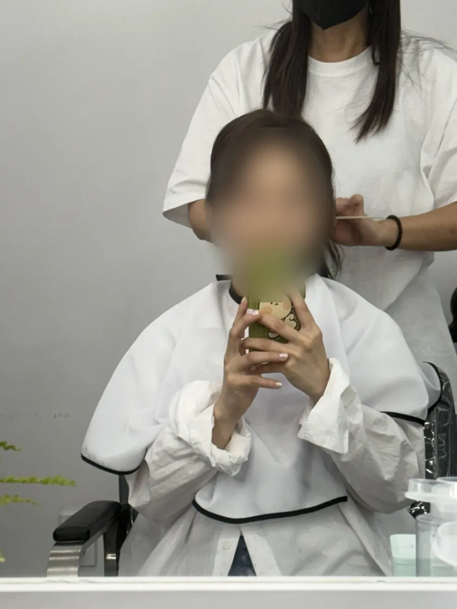 Mask on and hair consultation in progress