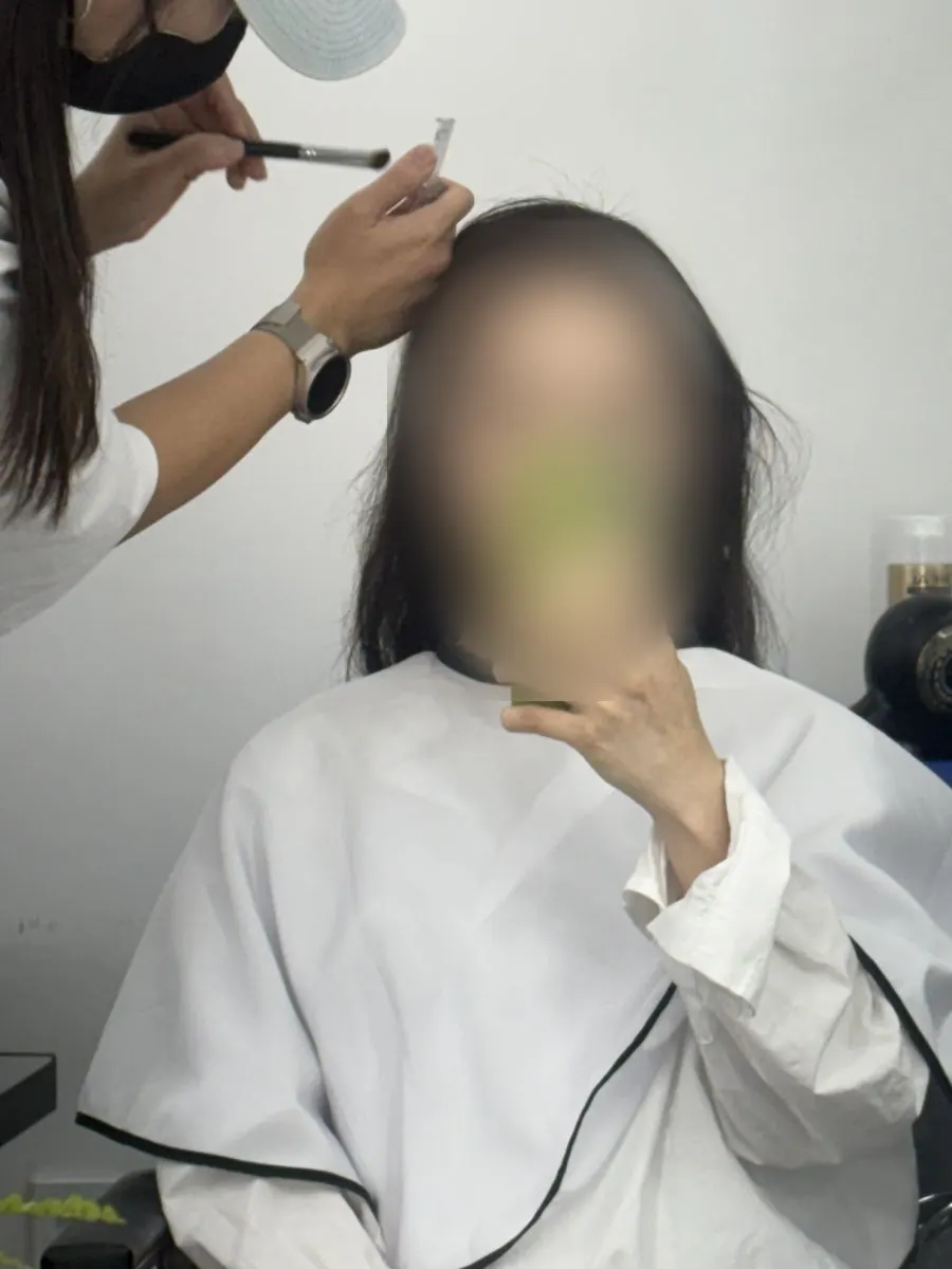 Flyaway-free slicked-back hair being styled