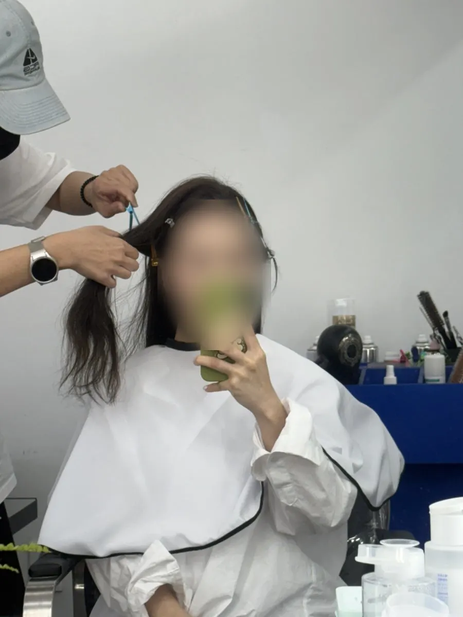 Strand-by-strand work on the slicked-back bun