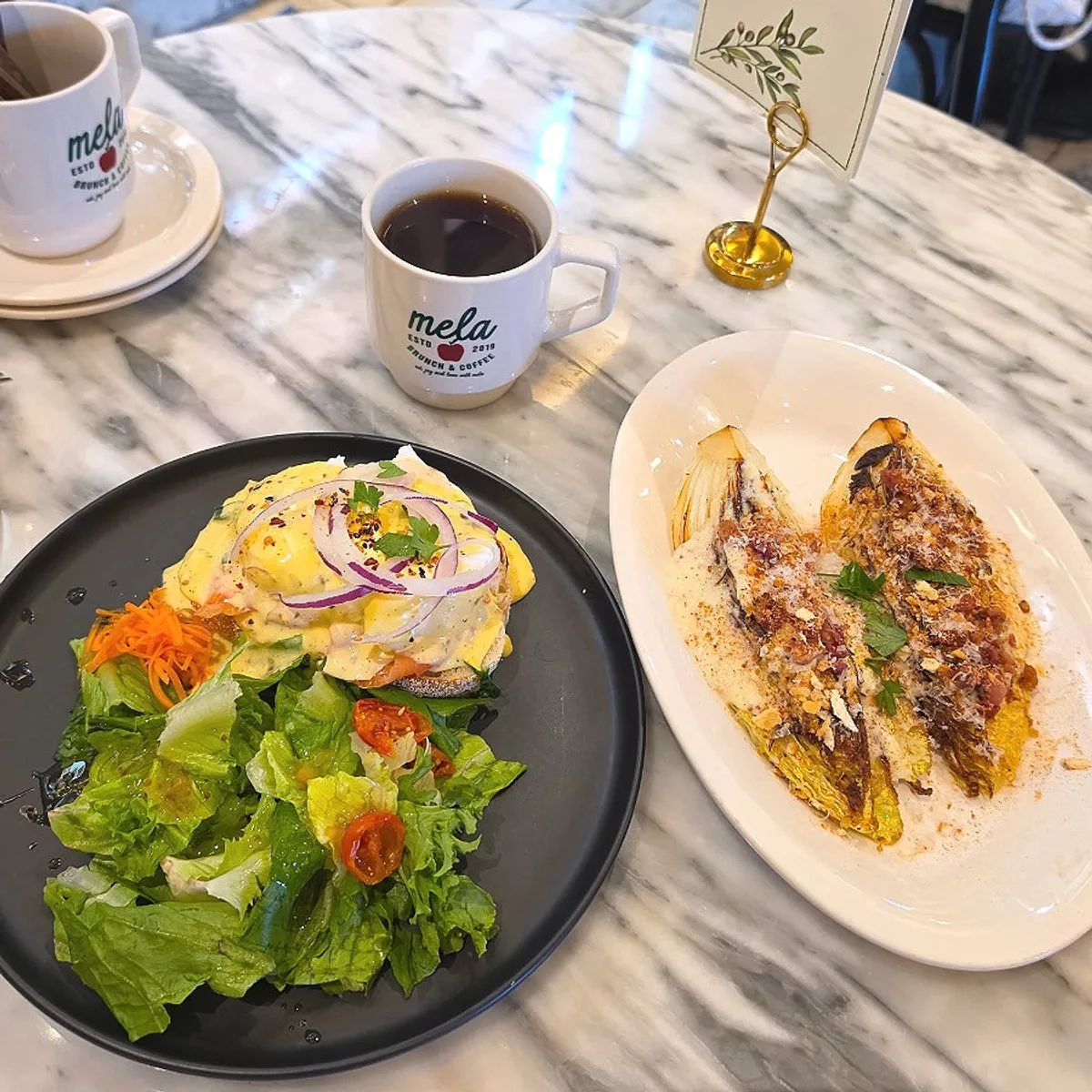 Salmon eggs Benedict and grilled napa cabbage salad order
