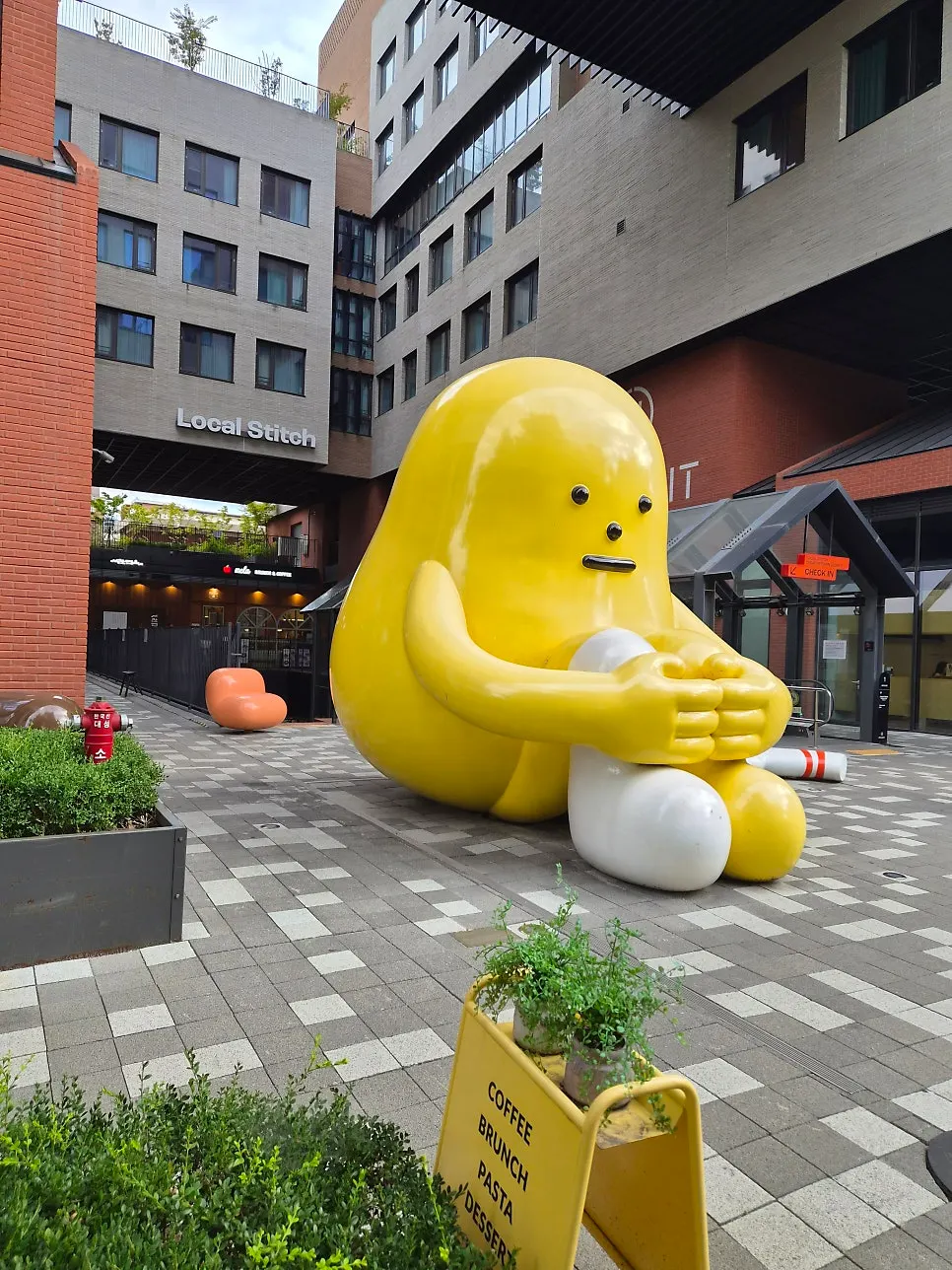 Exterior of MELA Hongdae in a Hongdae alley