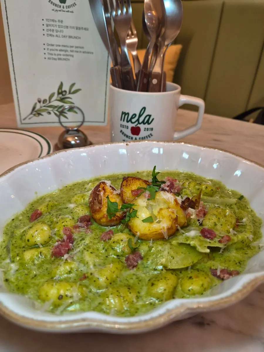 Gnocchi and baby potatoes coated in rich basil cream