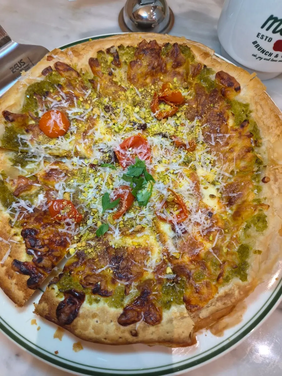 Pizza surface topped with pistachio powder