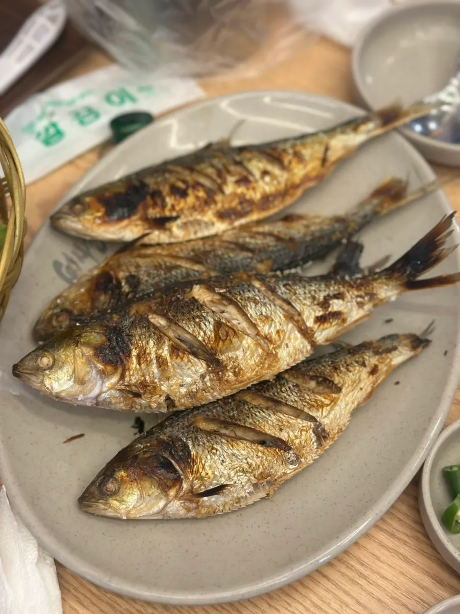Plate of golden-brown grilled gizzard shad