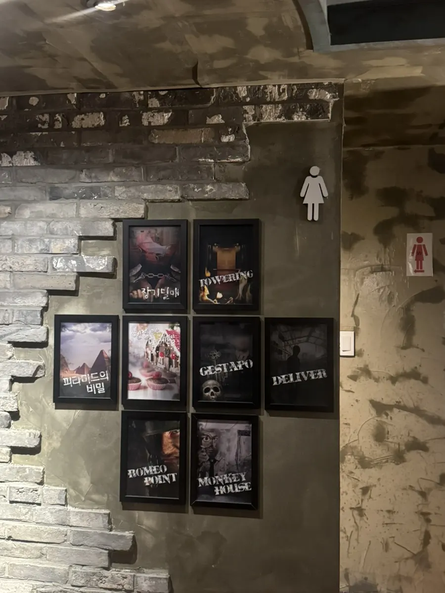 Signboard listing the 8 themes at Cube Escape Hongdae Branch