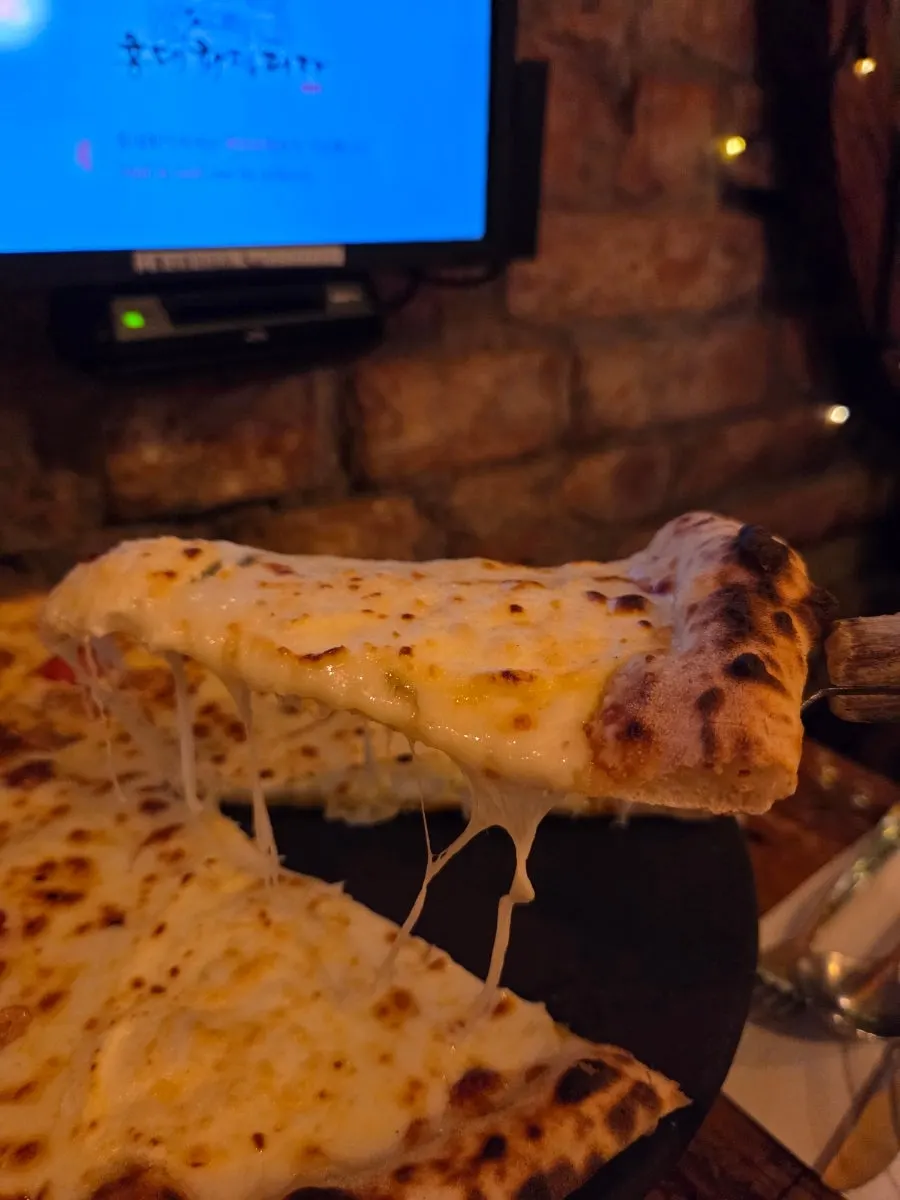 A slice of Croccante topped with shrimp and garlic chips