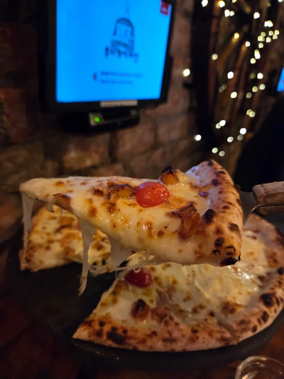 A slice of Quattro Formaggi with a rich cheese flavor