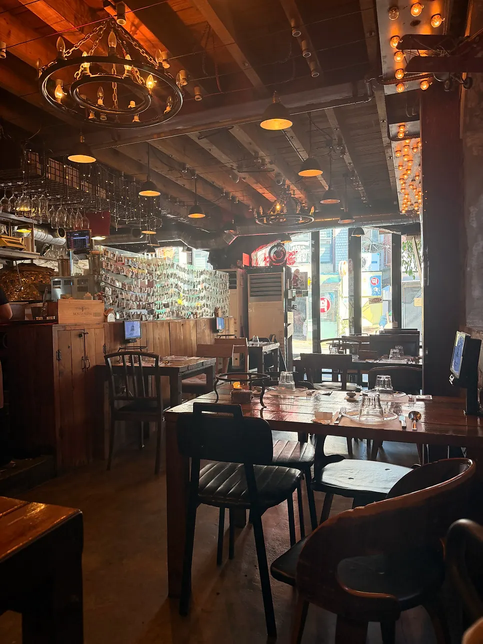 Wood-tone interior seating at Hongdae Hwadeok Pizza