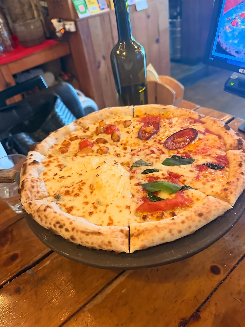 The four-flavor Quattro Stagioni pizza, whole pie
