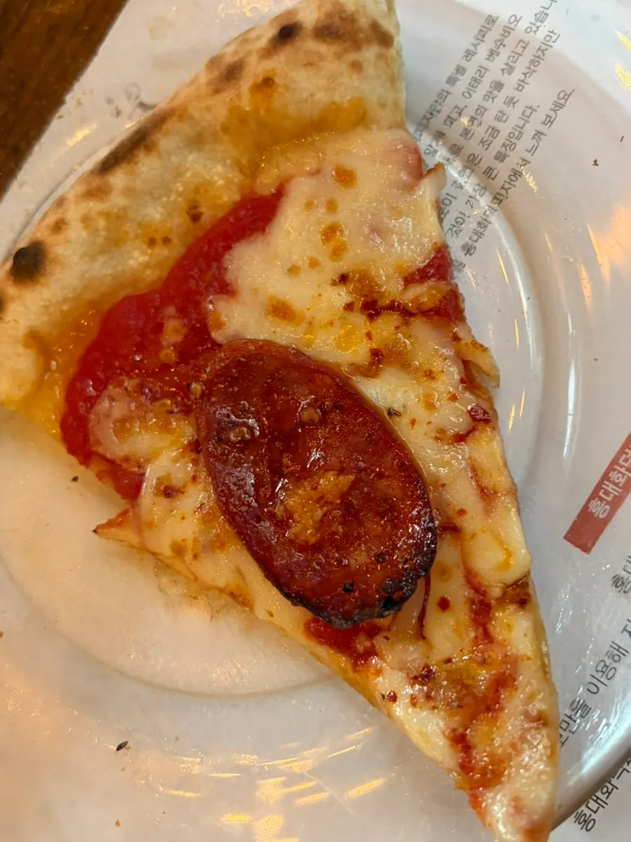 A slice of Croccante topped with shrimp and garlic chips