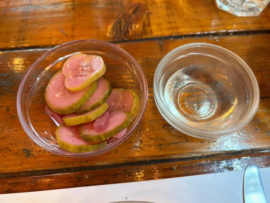 Pickles served alongside the pizza