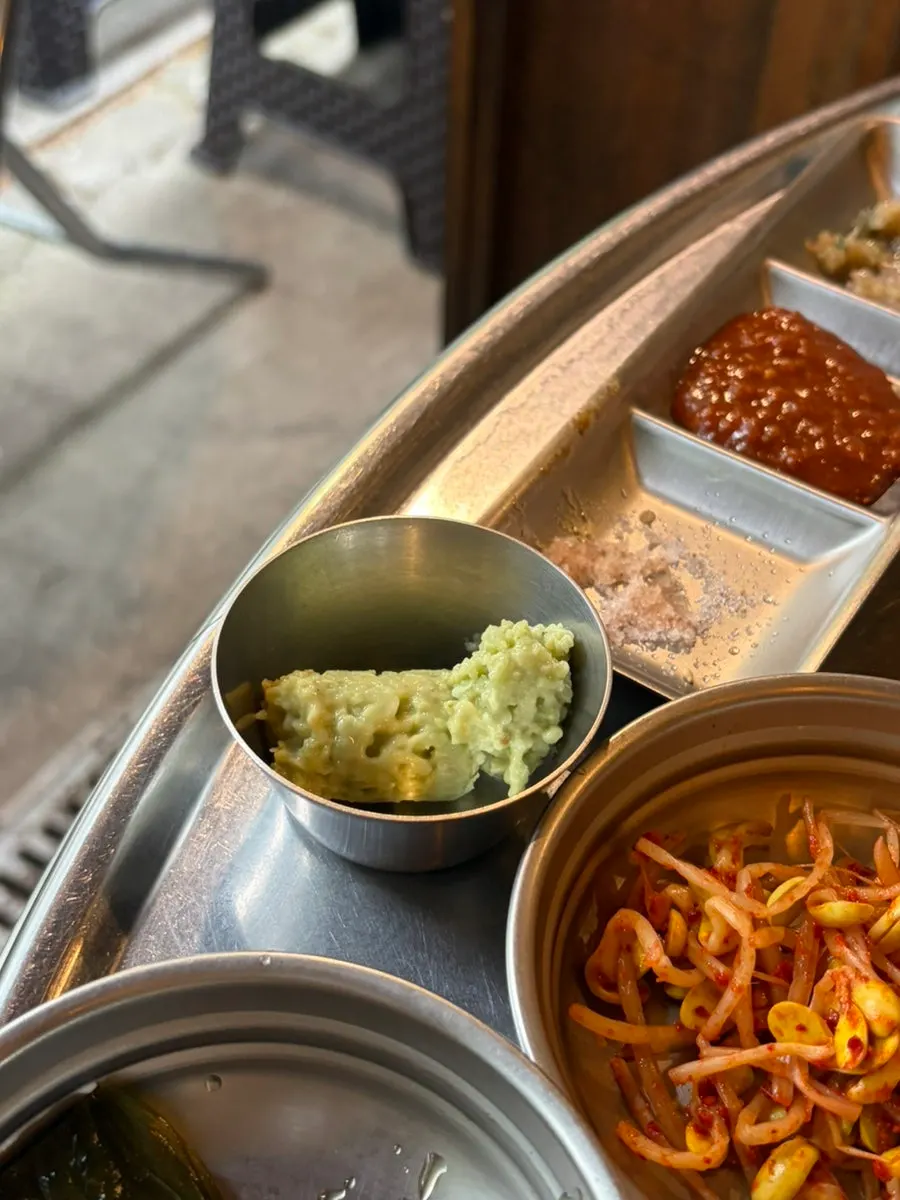 Plate of meat set against the forest path backdrop