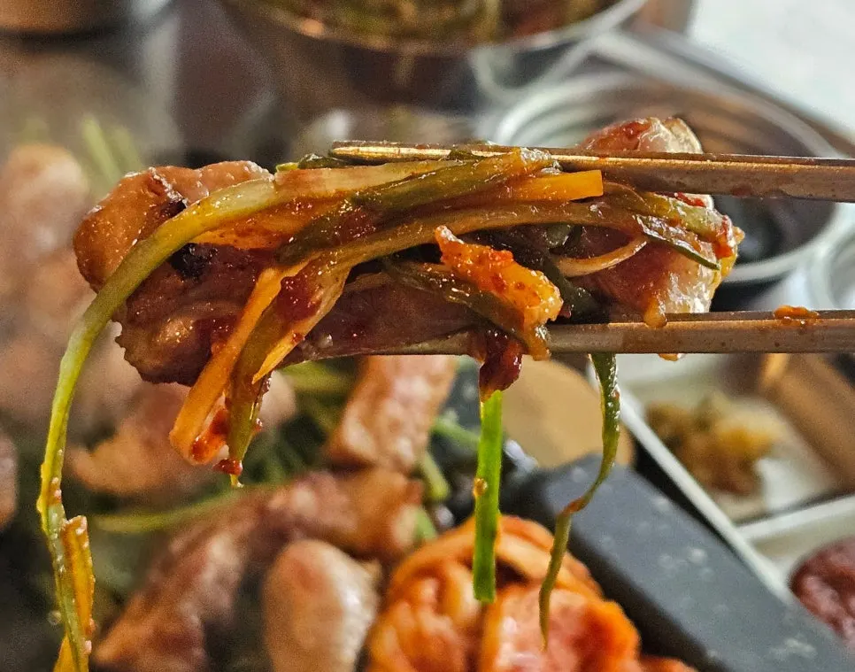 Pork neck topped with shredded scallion