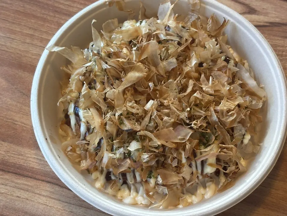 Okonomiyaki gyoza topped with bonito flakes