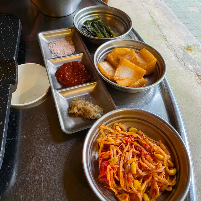 Side dishes including pickled onion and various sauces