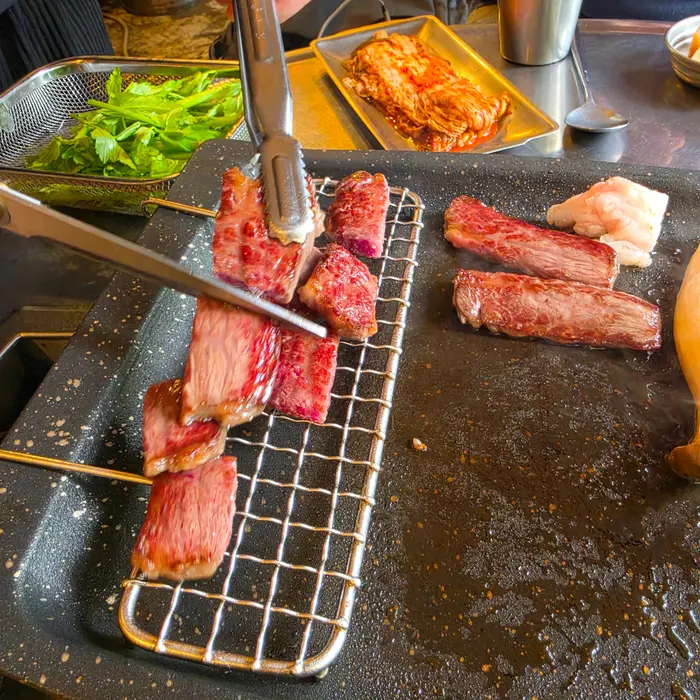 Hanwoo beef skirt steak cooking on the grill