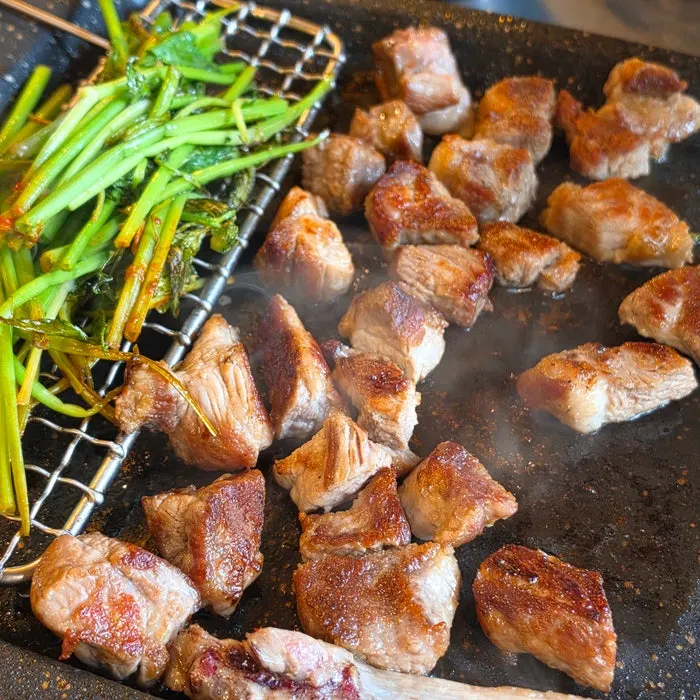 Staff member grilling the short rib