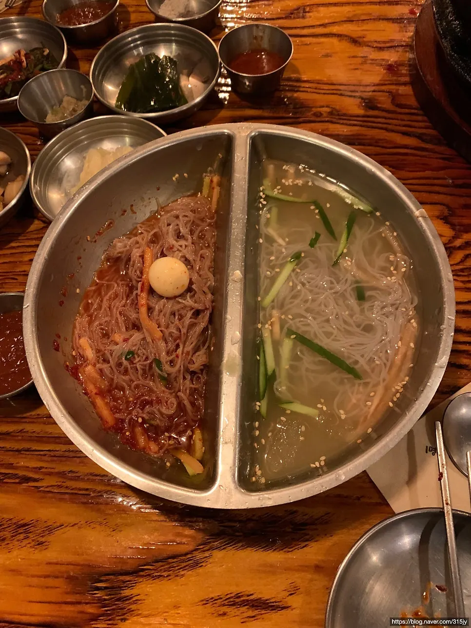 Half-and-half naengmyeon with water and bibim noodles side by side