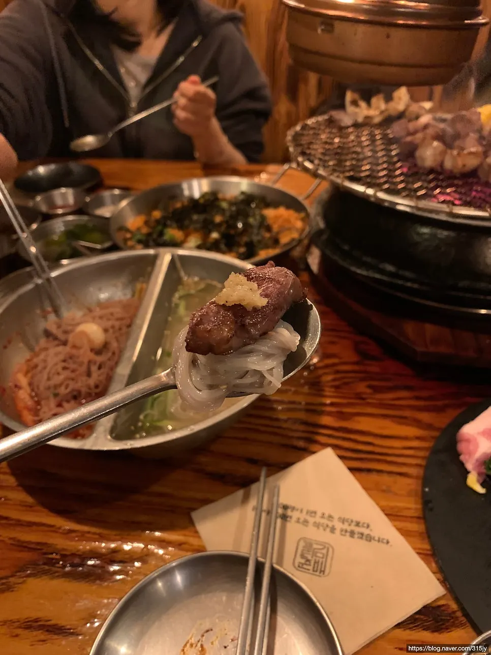 Grilled meat placed on top of naengmyeon