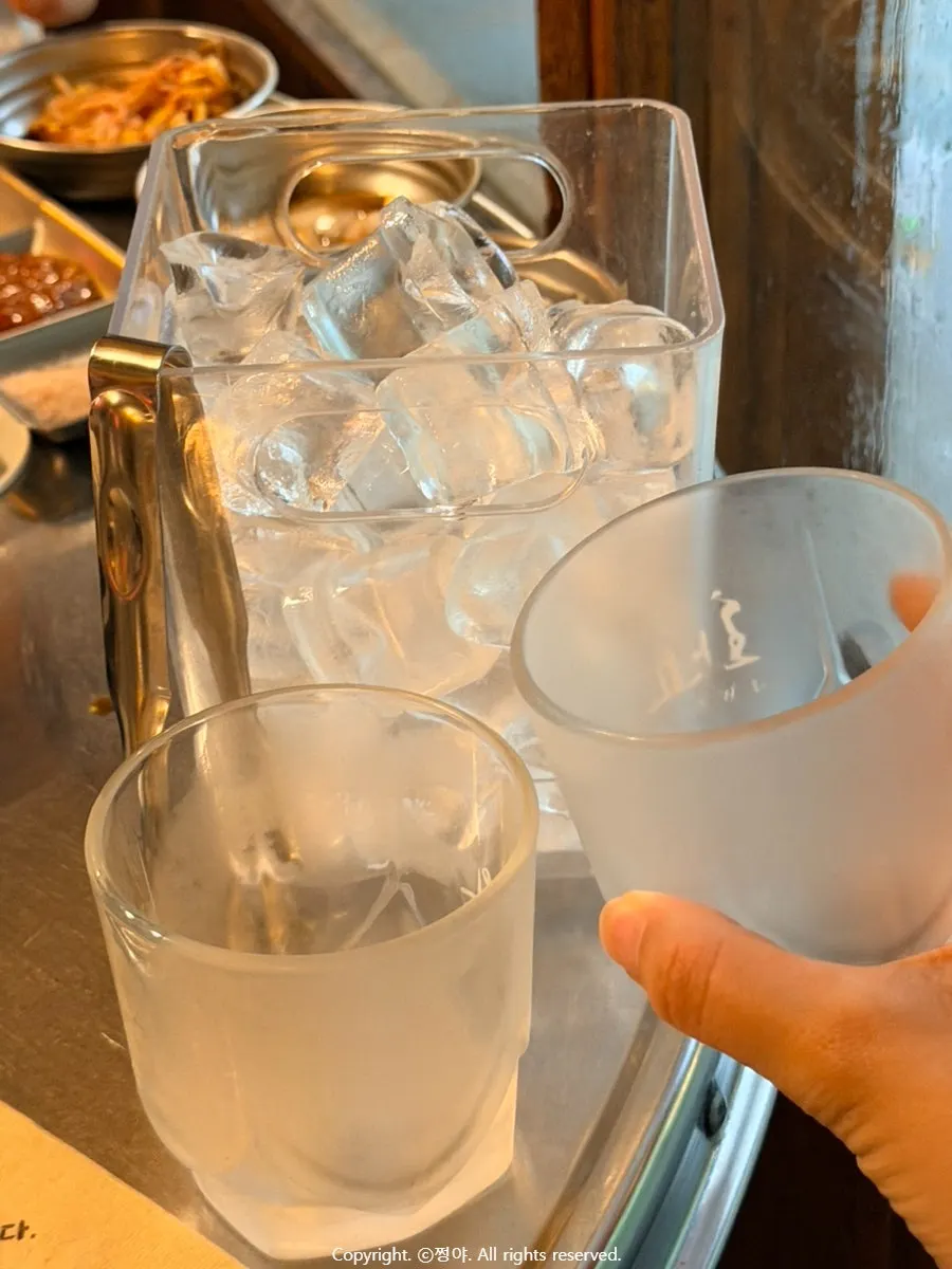 Whiskey glass and ice set up on the table