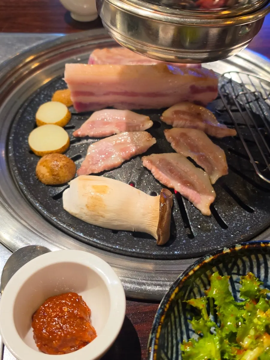 Meat sizzling on the grill at Gogi Salon