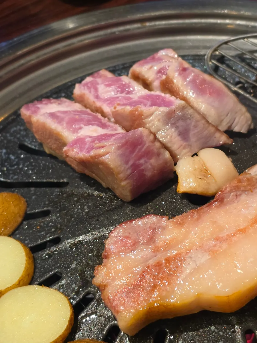 A piece of pork belly dipped in mustard