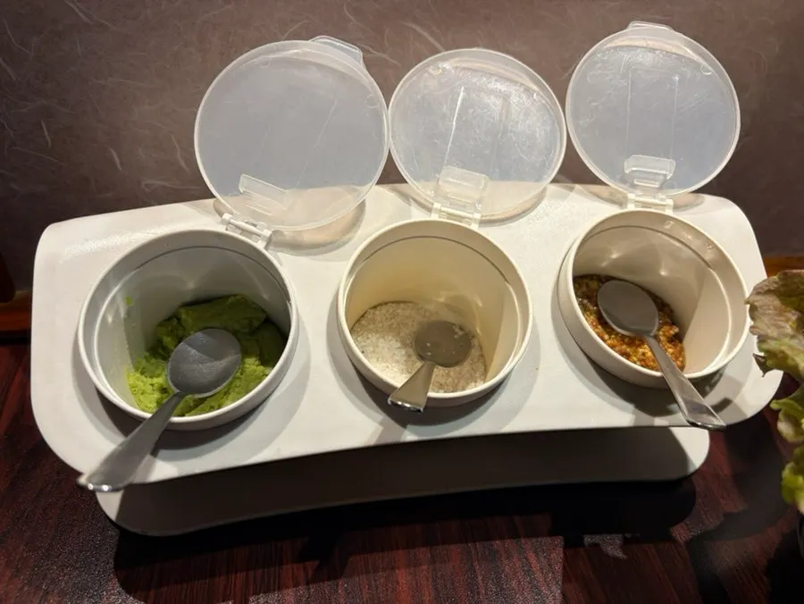 Side dishes including pickled peppers and pickled cucumber